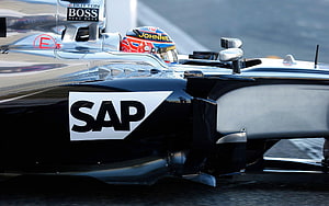 Close-up of a black and silver Formula 1 race car featuring prominent SAP and Boss sponsor logos on the sidepod and cockpit area HD wallpaper