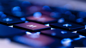 Close-Up of Backlit Mechanical Keyboard Keys in Blue and Red Tones HD wallpaper