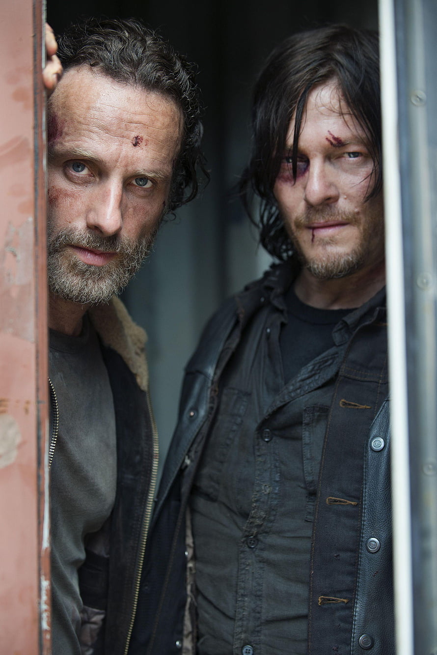 Rick Grimes and Daryl Dixon Peering Through a Rusty Doorway in The Walking Dead HD phone wallpaper
