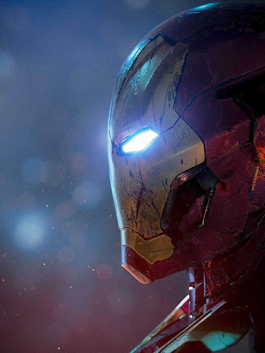 Damaged Iron Man Helmet Close-Up with Glowing Blue Eye in Dark Cinematic Setting, iron man 2022, #Iron Man HD phone wallpaper
