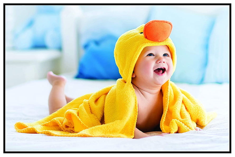 Happy Baby in Yellow Duck Hooded Towel Lying on White Bed HD wallpaper