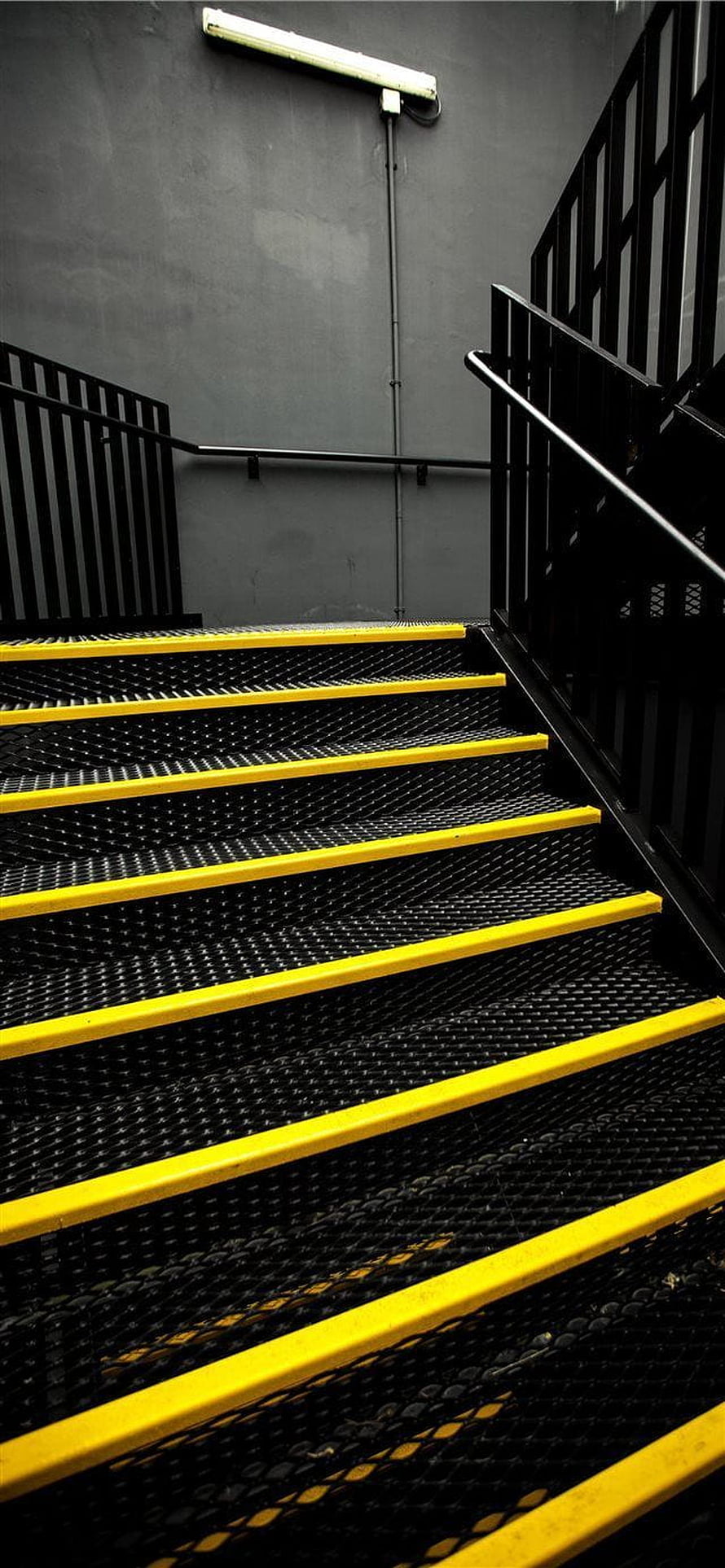 Industrial metal staircase with yellow safety edges and black railings HD phone wallpaper