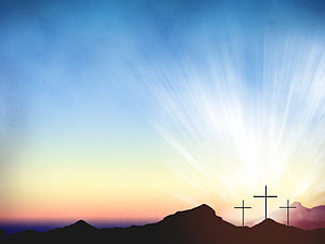 Three Crosses Silhouetted Against a Radiant Sunrise Over Mountain Peaks HD wallpaper