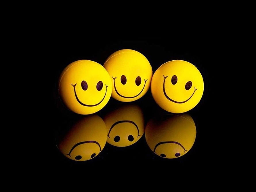 Three Yellow Smiley Balls with Reflections on a Black Background HD wallpaper