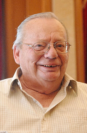 Ruskin Bond smiling portrait wearing glasses and a light checkered shirt HD phone wallpaper