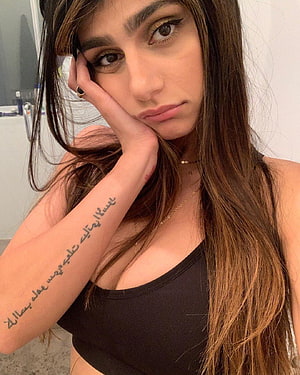 Mia Khalifa Close-Up Portrait With Long Hair And Arm Tattoo HD phone wallpaper