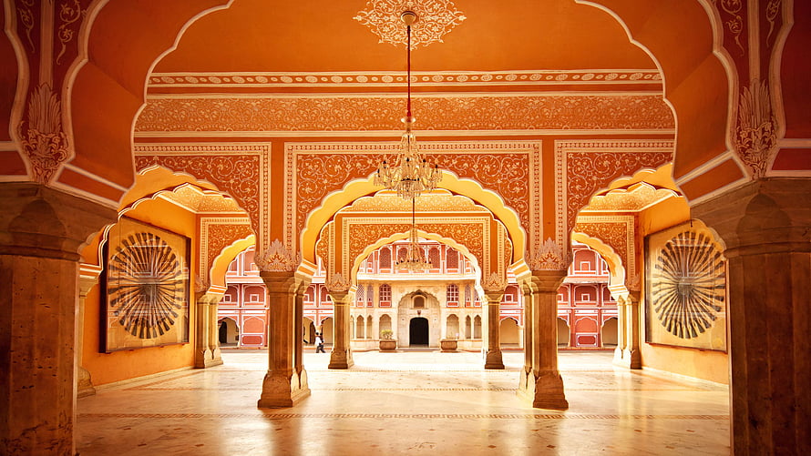 Ornate Indian Palace Interior With Intricate Arches And Warm Terracotta Walls HD wallpaper