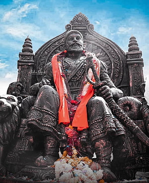 Chhatrapati Shivaji Maharaj Statue Seated on Throne with Sword and Red Garlands HD phone wallpaper