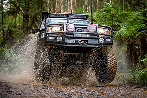 Custom Toyota Land Cruiser 79 Series Off-Roading Through Muddy Forest Trail HD wallpaper
