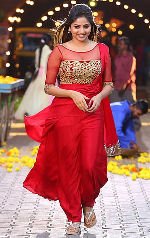 Rachita Ram in a vibrant red saree with gold embellished blouse walking on a street HD phone wallpaper