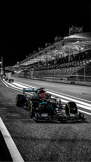 Mercedes-AMG Petronas Formula 1 car on the night race track HD phone wallpaper