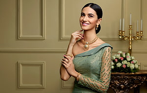 Elegant Indian Woman in Green Saree Wearing Traditional Gold Jewellery HD wallpaper