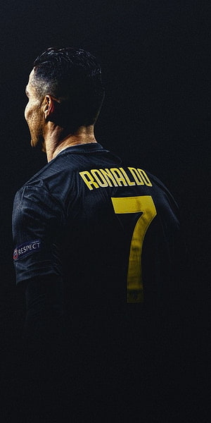 Cristiano Ronaldo in dark jersey with number seven and yellow lettering on black background HD phone wallpaper