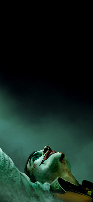 Joker Movie Character Looking Up in Dark Moody Atmosphere HD phone wallpaper