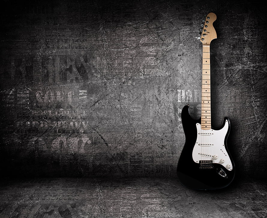 Black Electric Guitar Leaning Against Grunge Concrete Wall HD wallpaper