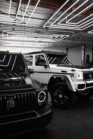 Tuned Mercedes G-Class SUVs in a Modern Garage with LED Lighting HD phone wallpaper