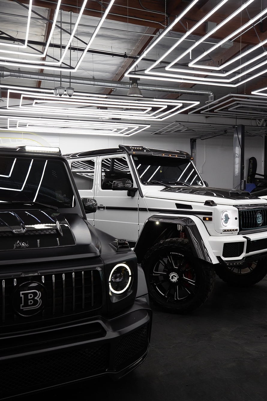 Tuned Mercedes G-Class SUVs in a Modern Garage with LED Lighting HD phone wallpaper