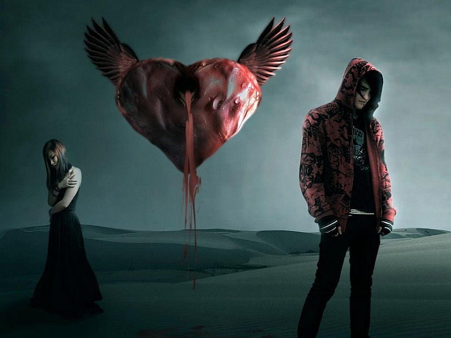 Gothic Sad Couple With Floating Winged Heart In Dark Desert Landscape HD wallpaper