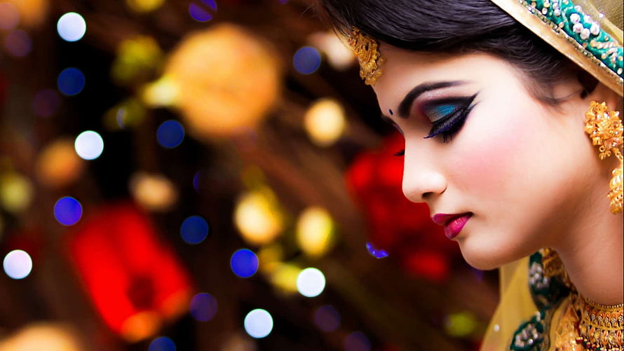 Elegant Indian Woman in Traditional Bridal Attire with Gold Jewelry and Dramatic Makeup HD wallpaper