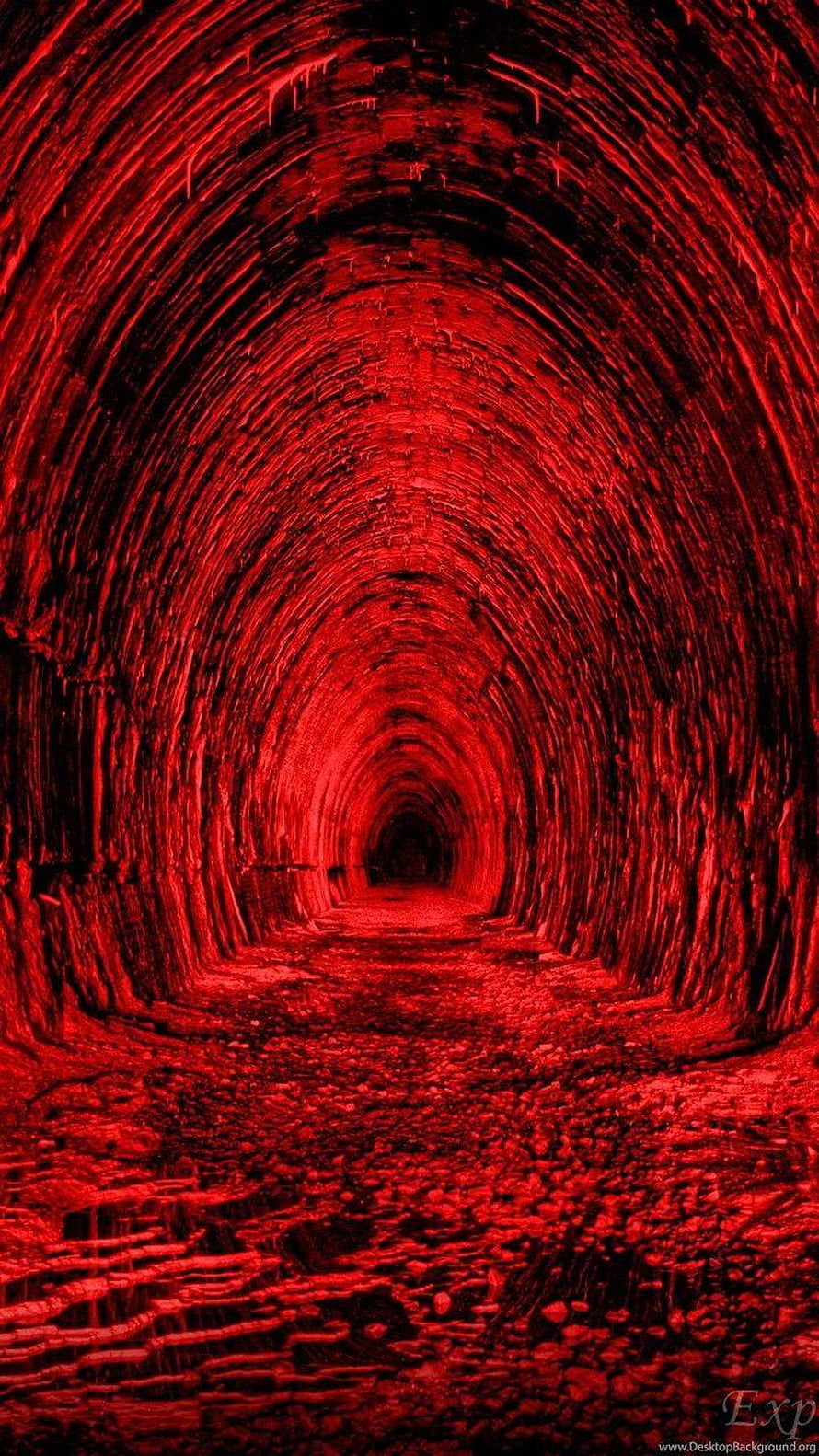 Eerie Red-Lit Stone Tunnel with Deep Perspective and Dark Atmosphere HD phone wallpaper
