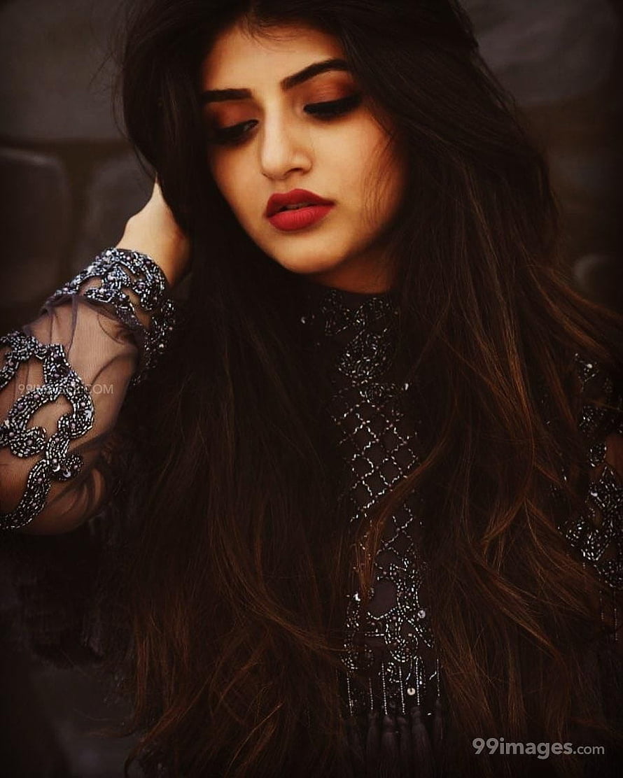 Sree Leela in an ornate black embroidered outfit with long wavy hair and bold red lipstick HD phone wallpaper