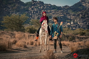 Gypsy Movie Still: Woman on White Horse and Man with Guitar in Arid Landscape HD wallpaper