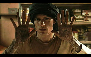Prison Break Character with Inked Hands and Headwrap in Dramatic Scene HD wallpaper