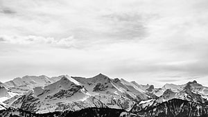 Monochrome Alpine Peaks Under Overcast Skies HD wallpaper
