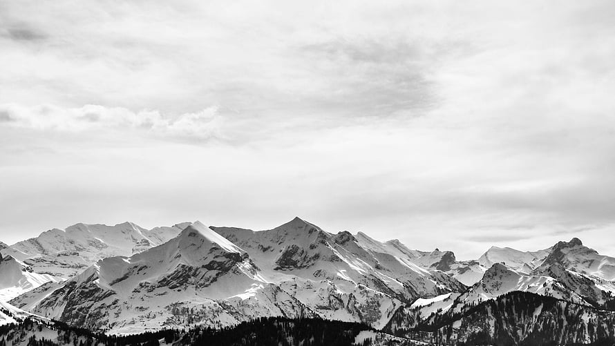 Monochrome Alpine Peaks Under Overcast Skies HD wallpaper