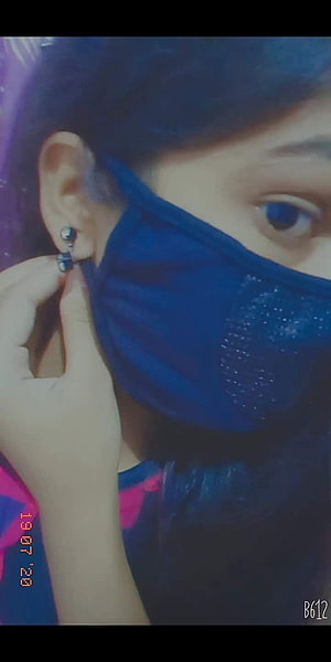 Close-up portrait of a person wearing a blue face mask and small stud earrings HD phone wallpaper