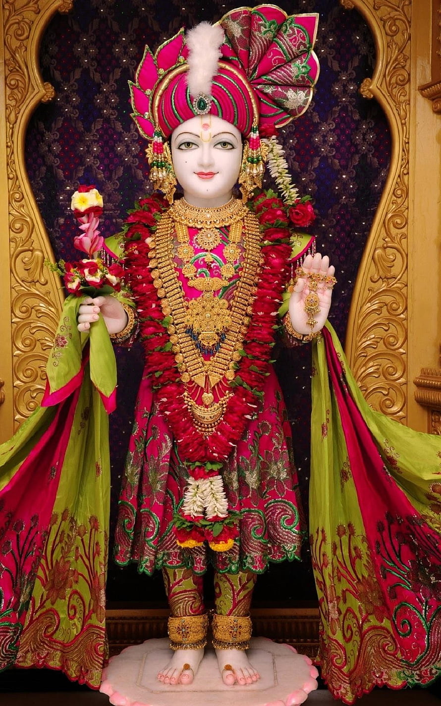 Ornate Swaminarayan Murti Adorned in Vibrant Pink and Green Silk with Gold Jewelry HD phone wallpaper