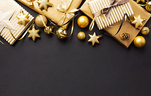 Luxury Gold Christmas Gift Boxes with Star Ornaments on Black Background HD wallpaper