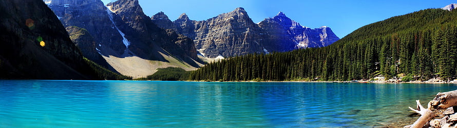 Turquoise Mountain Lake Surrounded by Pine Forest and Rocky Peaks HD wallpaper