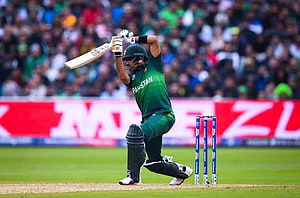Babar Azam in Pakistan green kit playing a cricket shot at the stumps HD wallpaper