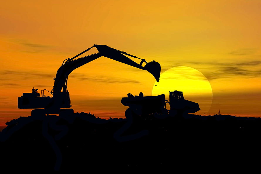 Excavator and Dump Truck Silhouetted Against a Golden Sunset at a Construction Site HD wallpaper