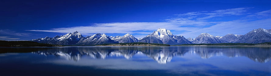 Snow-Capped Mountain Range Reflected in a Calm Alpine Lake Under a Deep Blue Sky HD wallpaper