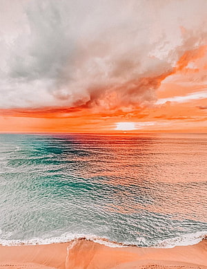 Vibrant Ocean Sunset Over Sandy Shore With Dramatic Clouds HD phone wallpaper