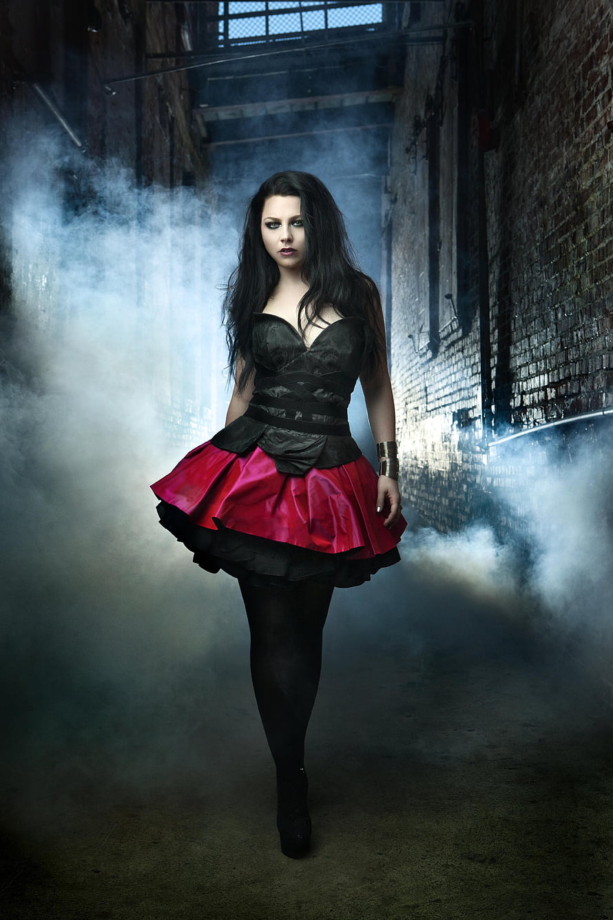 Amy Lee in a black and red gothic dress standing in a smoky industrial alleyway HD phone wallpaper