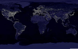 Illuminated World Map at Night with City Lights on Dark Blue Background HD wallpaper