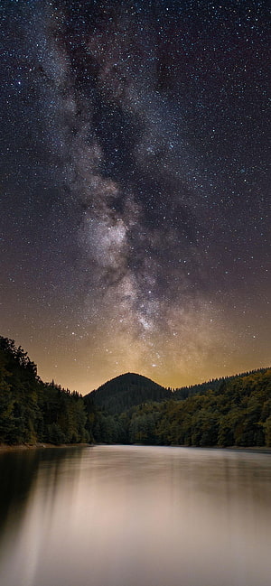 Milky Way Galaxy Rising Over a Serene Mountain Lake at Night HD phone wallpaper