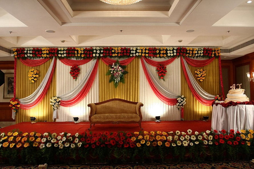 Elegant Indian Wedding Stage Setup With Floral Drapes And Vintage Sofa HD wallpaper