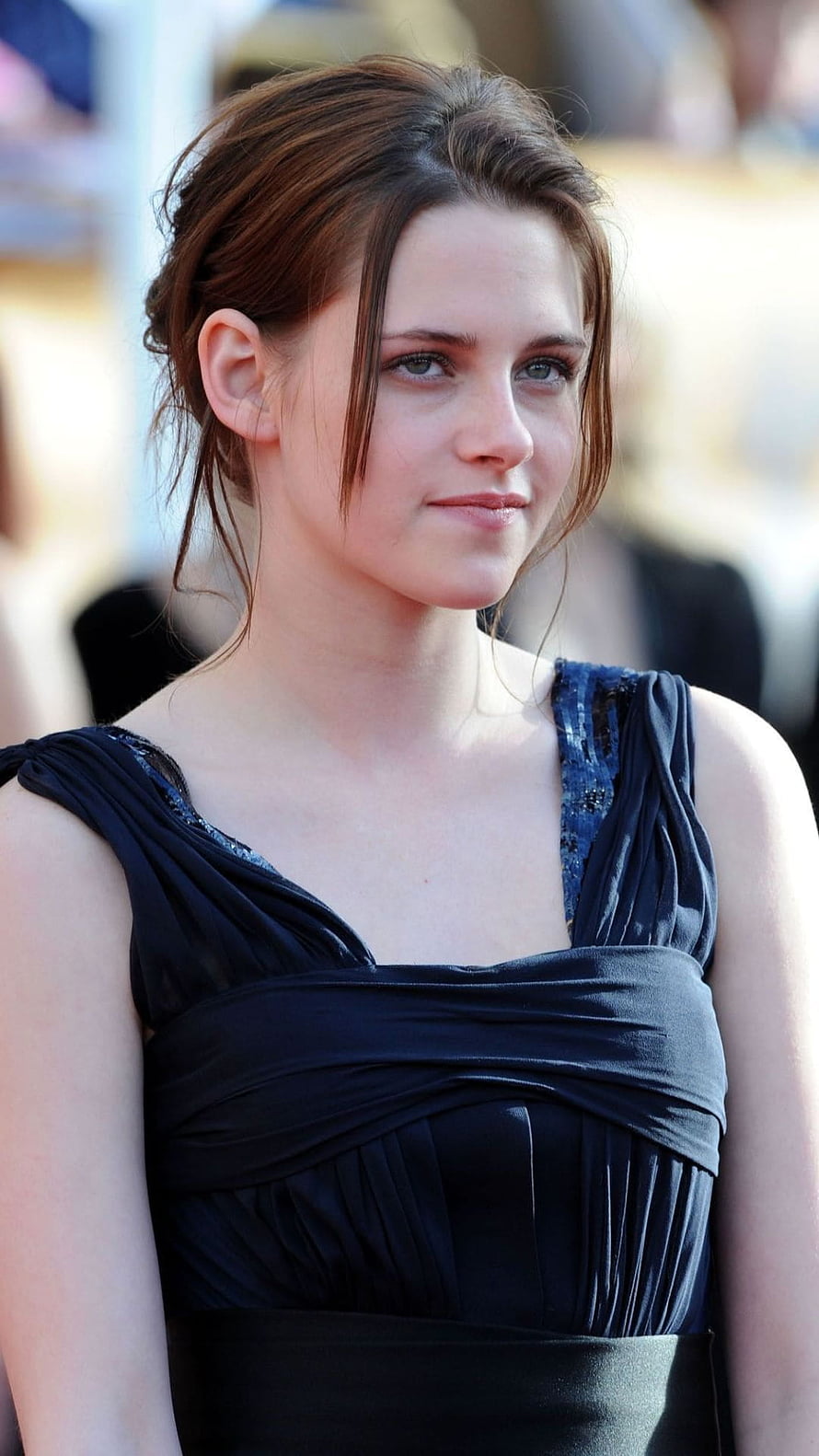Kristen Stewart in an elegant navy blue draped evening gown at a formal event HD phone wallpaper