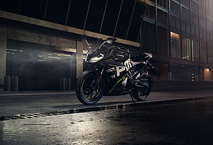 CFMoto sport motorcycle parked on wet urban street at night with neon accents HD wallpaper