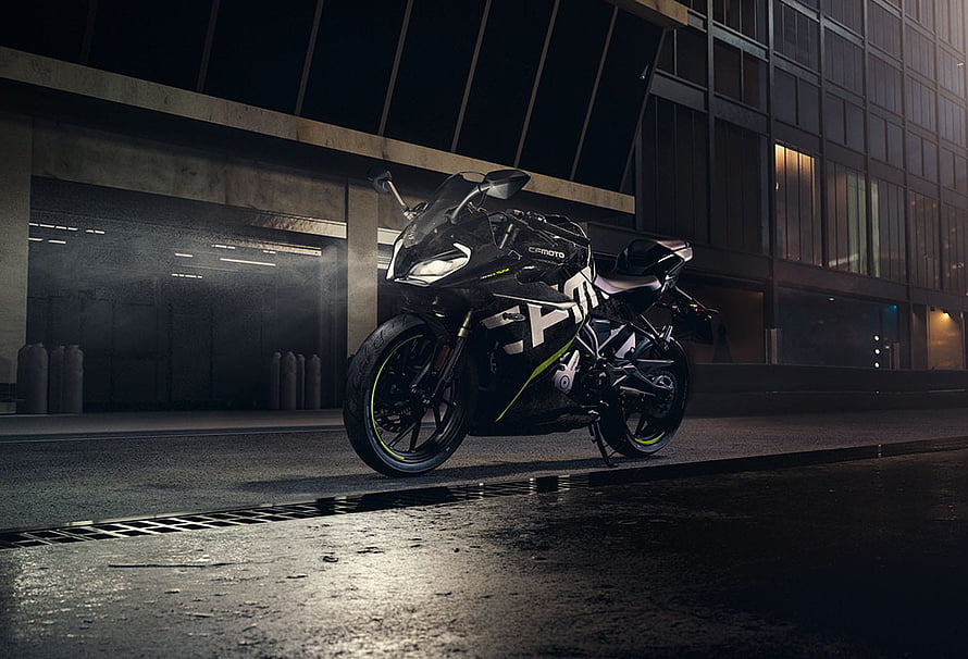 CFMoto sport motorcycle parked on wet urban street at night with neon accents HD wallpaper