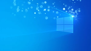 Windows 11 Default Blue Desktop Background with Glowing Window Logo and Bokeh Light Particles HD wallpaper