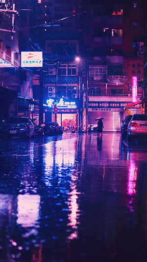 Neon-lit rainy night street in Taipei with reflections and a lone figure under an umbrella HD phone wallpaper