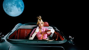 Dua Lipa in a vintage convertible under a blue moon with a pink shirt and white gloves HD wallpaper