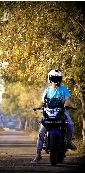 Bajaj Pulsar 220F Rider on a Tree-Lined Road in Golden Hour Light HD phone wallpaper