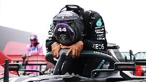 Lewis Hamilton in Mercedes F1 Helmet Leaning on Car During Race HD wallpaper