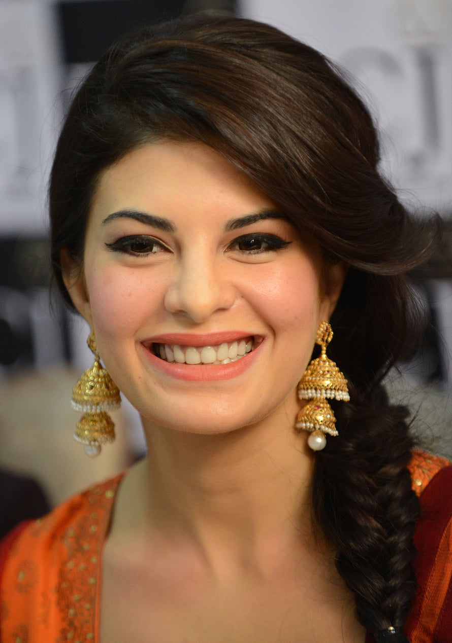 Jacqueline Fernandez Portrait in Traditional Orange Attire with Gold Jhumka Earrings HD phone wallpaper